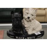 A VINTAGE BLACK AND WHITE WHISKY DOGS BAR DISPLAY