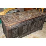 A LARGE 19TH CENTURY CARVED OAK COFFER WITH CANDLE DRAWER TO THE INSIDE W-143 CM