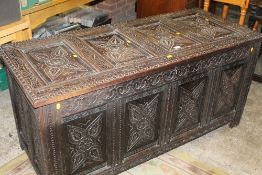 A LARGE 19TH CENTURY CARVED OAK COFFER WITH CANDLE DRAWER TO THE INSIDE W-143 CM