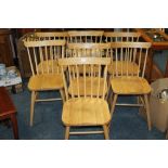 A SET OF SEVEN MODERN LIGHT OAK DINING CHAIRS