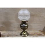 A BRASS OIL LAMP WITH BRASS ETCHED SHADE