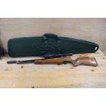 A FALCON AIR RIFLE WITH SIMMONS 6"18 X 40 ADJUSTABLE SIGHT IN A NAPIER OF LONDON TRAVEL PADDED CASE