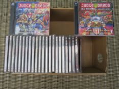 A BOX CONTAINING APPROXIMATELY 24 JUDGE DREDD CD'S, TO INCLUDE THE TWO CD ORIGINAL ADVENTURES