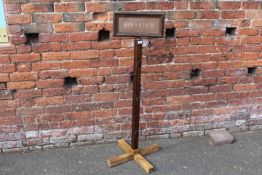 A VINTAGE ADVERTISING SIGN FOR 'BISSELL'S', ON A WOODEN STAND