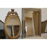 A MODERN RECTANGULAR MIRROR AND AN OVAL MIRROR (2)