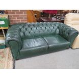 A GREEN LEATHER CHESTERFIELD SETTEE