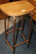 A MODERN STOOL WITH COPPER LEGS