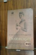 A VINTAGE CARDBOARD ADVERTISING SIGN FOR CHARMLIGHT LAMPS. OIL ON BOARD VERSO H.RH IMPRESSIONIST