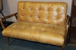 A MODERN TAN LEATHER TWO SEATER UPHOLSTERED SETTEE