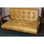 A MODERN TAN LEATHER TWO SEATER UPHOLSTERED SETTEE