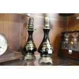 A PAIR OF FRENCH GILT METAL MOUNTED BLACK CERAMIC OIL LAMPS