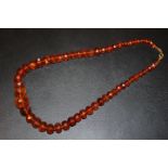 AN AMBER FACETED BEAD NECKLACE