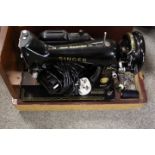 A CASED ELECTRIC SINGER SEWING MACHINE MODEL NUMBER EM935581