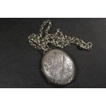 A LARGE VICTORIAN SILVER LOCKET AND CHAIN