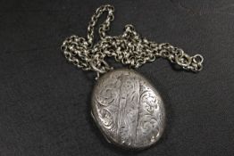 A LARGE VICTORIAN SILVER LOCKET AND CHAIN