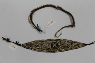 A VINTAGE PAPUA NEW GUINEA NECKLACE DECORATED WITH COWRIE SHELLS, together with a vintage Papua