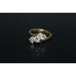 AN 18 CARAT GOLD 1 CARAT THREE STONE DIAMOND RING, the central brilliant cut diamond being of an