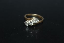 AN 18 CARAT GOLD 1 CARAT THREE STONE DIAMOND RING, the central brilliant cut diamond being of an