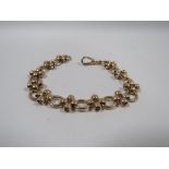 A 9CT GOLD DECORATIVE BRACELET, hallmarked to first large oval link nearest to clasp, approx