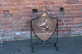A SHIELD SHAPED COPPER AND BENT IRON WORK FIRESCREEN, with rampant lion decoration, H 84.5 cm