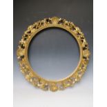 A 19TH CENTURY CIRCULAR CARVED WOODEN GOLD FLORENTINE FRAME, frame W 9.5 cm, rebate Dia. 51 cm