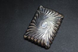 GEORGE UNITE - A HALLMARKED SILVER CARD CASE - LONDON 1889, having a swirling sun ray style repousse