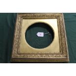 AN 18TH CENTURY DECORATIVE GOLD FRAME, with circular gold slip, frame W 5.5 cm, slip site size