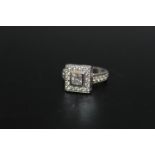 A HALLMARKED HANDMADE 18 CARAT WHITE GOLD DIAMOND RING, set with a central Princess cut diamond of