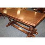 A JAYCEE OAK DRAWLEAF DINING TABLE, having an unusual twin baluster carved column structure,