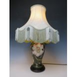 A LARGE MOORCROFT FLORAL PATTERN TABLE LAMP, dark green ground to lamp base, with shade, H 30 cm (