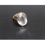 A 9CT GOLD DRESS RING, set with a large polished clear quartz style stone, approx 22 mm by 14 mm,