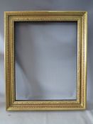 A LATE 19TH / EARLY 20TH CENTURY GOLD FRAME, with design to inner edge, frame W 9 cm, rebate 79 x 63