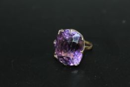 A VERY LARGE AMETHYST RING, the cushion cut style stone measures an approx 24 mm by 21 mm and is set