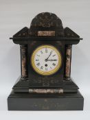 A LARGE BLACK SLATE MANTLE CLOCK WITH VARIEGATED MARBLE EMBELLISHMENT, having a single train
