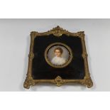 A 19TH CENTURY CIRCULAR PORTRAIT STUDY OF A YOUNG WOMAN ON CERAMIC PANEL, unsigned, framed in