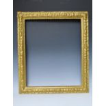 A LATE 19TH / EARLY 20TH CENTURY DECORATIVE GOLD FRAME, with bead design to inner edge and plant