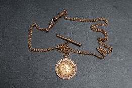 A HALLMARKED 9 CARAT ROSE GOLD WATCH CHAIN AND T-BAR WITH 9CT GOLD PRESENTATION MEDALLION FOR