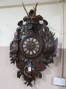 A VERY LARGE 19TH CENTURY BLACK FOREST HUNTING THEMED WALL CLOCK, the heavily carved case displaying