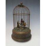 AN EARLY 20TH CENTURY MUSICAL / AUTOMATON BIRD CAGE, with three birds on a naturalistic setting, H 2