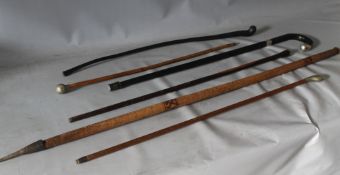 AN EBONISED WALKING STICK WITH SILVER MOUNTED AND TWO MILITARY SWAGGER STICKS / CANES, together with