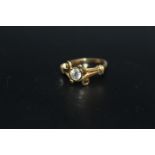 A HALLMARKED 18 CARAT GOLD HALF CARAT DIAMOND RING, in an unusual split swirl band setting, the