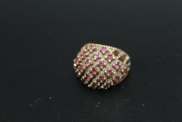 A 9CT RAISED GALLERY RUBY RING, set with 23 rubies approx weight 7.1g, ring size O