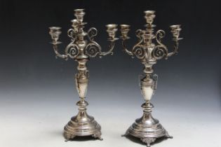 A PAIR OF UNMARKED WHITE METAL CANDLESTICKS, having central twin handled urn design central column