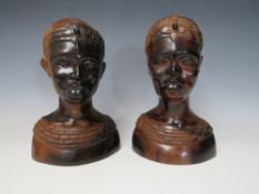 A PAIR OF LATE 19TH / EARLY 20TH CENTURY TRIBAL CARVED HEADS, depicting typical female African