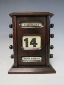 AN EARLY PERPETUAL DESK CALENDAR, with apertures for day, date and month, H 17 cm