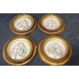 A SET OF FOUR CIRCULAR GILT FRAMED PORCELAIN PLAQUES DEPICTING THE FOUR SEASONS, each with convex