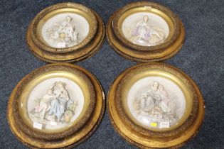 A SET OF FOUR CIRCULAR GILT FRAMED PORCELAIN PLAQUES DEPICTING THE FOUR SEASONS, each with convex