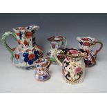 A COLLECTION OF FOUR ASSORTED MASONS IRONSTONE JUGS, together with a modern equivalent, largest H 19