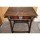 A MID 17TH CENTURY OAK COUNTRYMADE JOINTED SIDE TABLE, with a single frieze drawer, raised in barrel