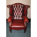 A 20TH CENTURY OXBLOOD LEATHER WINGBACK ARMCHAIR